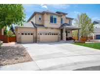 Lovely two-story home featuring a three car garage and covered front porch at 11460 W Tanforan Cir, Littleton, CO 80127