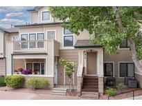 Charming townhome featuring a front patio with beautiful flower planters and a welcoming entrance at 8707 E Florida Ave # 614, Denver, CO 80247