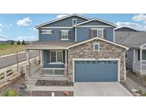 Beautiful two-story home boasts a stone-accented facade and a charming covered front porch at 2188 Abigail Ln, Castle Rock, CO 80104