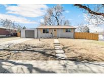 Charming single-story home with a well-maintained front yard, driveway, and detached garage at 315 S Xapary St, Aurora, CO 80012