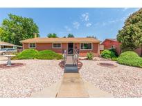 Charming brick home with a well-maintained yard, walkway, and tasteful landscaping at 3225 W Mexico Ave, Denver, CO 80219