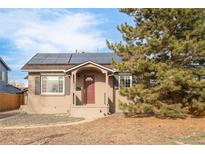 Charming single-story home featuring solar panels, a covered porch, and mature landscaping at 185 S Eliot St, Denver, CO 80219