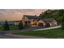 Beautiful two-story home with three-car garage, manicured lawn, and a scenic mountain view at 6402 Wauconda Dr, Larkspur, CO 80118