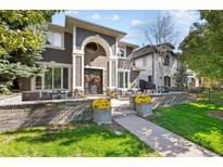 Exterior of a two-story house with landscaping and a walkway at 290 Glencoe St, Denver, CO 80220