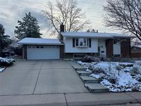Charming single-Gathering home featuring a two-car garage and a well-maintained front yard in winter at 3770 S Ulster St, Denver, CO 80237
