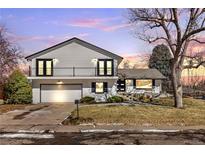 Charming two-story home featuring a balcony, well-maintained lawn, and an attached two-car garage at 6655 W Glasgow Ave, Littleton, CO 80128