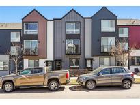 Street view of modern townhomes with unique architectural details and a mix of exterior finishes at 1064 Depew St, Lakewood, CO 80214