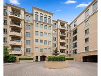 Elegant building exterior features a fountain, arched windows, and multiple balconies providing a refined and inviting atmosphere at 2500 E Cherry Creek South Dr # 313, Denver, CO 80209