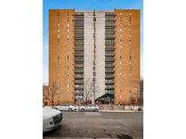 Brick building with balconies, concrete center, dark awning, and sidewalk access to main entrance at 955 Eudora St # 307E, Denver, CO 80220