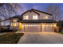 Charming two-story home features a three-car garage, stone accents and neutral stucco at 7636 S Allison Ct, Littleton, CO 80128