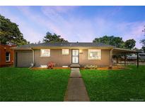 Charming brick home featuring a lush green lawn and walkway leading to the front door at 4300 Osage St, Denver, CO 80211