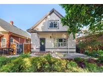 Charming home featuring a well-manicured lawn, updated windows, and stylish exterior paint at 623 S Logan St, Denver, CO 80209