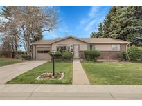 Charming single-story home featuring a well-manicured lawn and inviting brick accents at 6832 S Birch Way, Centennial, CO 80122