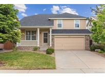 Charming two-story home with a well-manicured lawn, inviting porch, and a two car garage at 4016 S Rome St, Aurora, CO 80018