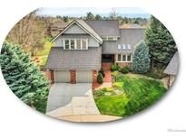 Beautiful two-story home with a well-manicured lawn, brick accents and a two car garage at 6505 S Garfield Ct, Centennial, CO 80121