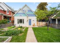 Inviting home with a walkway, beautiful lawn, and a charming front exterior at 2944 Hooker St, Denver, CO 80211