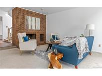 Comfortable living room with a brick fireplace, modern furniture, and neutral décor at 999 N Emerson St # 10, Denver, CO 80218