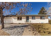 Charming single-story brick home with a well-manicured lawn and inviting front entrance, plus attached garage at 6699 S Pennsylvania St, Centennial, CO 80121