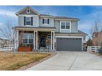 Two-story house with gray siding, stone accents, and a two-car garage at 1682 Dorothy Cir, Longmont, CO 80503