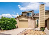 Inviting home exterior showing a charming two-story design, garage, and well-maintained landscaping at 10309 W Fair Ave # E, Littleton, CO 80127