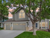 Charming gray two-story home with a well-manicured lawn and a three-car garage at 6726 W 97Th Cir, Westminster, CO 80021