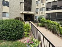 Inviting building entrance with accessible ramp, lush landscaping, and visible building number for easy identification at 13890 E Marina Dr # 602, Aurora, CO 80014