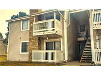 Inviting condo featuring stone accents, two balconies, and well-maintained siding at 14102 E Colorado Dr # 102, Aurora, CO 80012