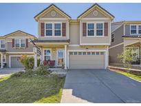 Charming two-story home with tan siding, red shutters, and a well-maintained front yard at 2508 Coach House Loop, Castle Rock, CO 80109