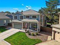 Charming two-story home with a well-manicured front yard and covered front porch in a suburban neighborhood at 6242 Shea Pl, Highlands Ranch, CO 80130