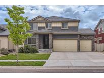 Attractive two story home featuring manicured front yard and three car attached garage at 133 Poppy View Ln, Erie, CO 80516