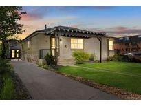Charming home with a modern pergola and a well-manicured lawn creating great curb appeal at 785 Dexter St, Denver, CO 80220