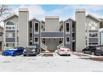 Modern condo building with covered parking and snowy front lot and beautiful blue and gray exterior at 4855 Edison Ave # 112, Boulder, CO 80301