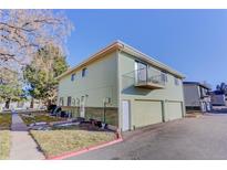 Light green exterior of the house with a two-car garage and balcony at 3225 S Garrison St # 41, Lakewood, CO 80227