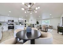 Open-concept layout featuring a modern kitchen, dining area, and comfortable living room at 6876 Quay Ct, Arvada, CO 80003