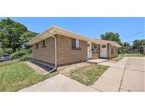 Charming brick home featuring a well-maintained front yard and inviting entrance at 1148 Rosemary St, Denver, CO 80220