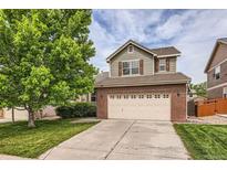 Two story home with brick veneer and two car garage on a sunny day at 2856 Penstemon Way, Castle Rock, CO 80109