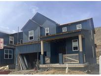 New construction shows a two-story home with a covered porch and unfinished landscaping at 7367 S Yank Ct, Littleton, CO 80123