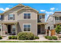 Charming townhome featuring a well-manicured lawn and neutral-toned exterior under a bright, partly cloudy sky at 17548 Bluetrail Ave, Parker, CO 80134