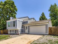 Charming home featuring a well-maintained yard, driveway, and a two-car garage, offering comfortable suburban living at 1956 Cathay St, Aurora, CO 80011