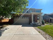 Two story home with a two car garage and a covered front porch at 4824 S Eaton Park Way, Aurora, CO 80016