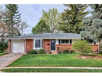 Charming single-story brick home featuring a well-manicured lawn and mature trees at 6587 S Clarkson St, Centennial, CO 80121