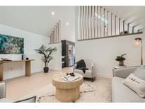 Modern living room featuring stylish decor, hardwood floors, and comfortable seating arrangements at 1101 S Dahlia St, Denver, CO 80246