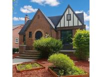 Charming brick Tudor-style home with a well-manicured front yard and unique architectural details at 1470 Utica St, Denver, CO 80204