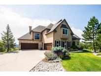 Beautiful two-story home with stone accents, lush landscaping, and a three-car garage at 4320 Stone Post Dr, Castle Rock, CO 80108