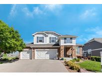Inviting two-story home showcasing a three-car garage and charming stone and siding exterior at 4515 W 107Th Cir, Westminster, CO 80031