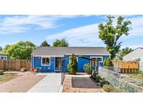 Charming blue single-story home with a well-maintained front yard and unique covered parking at 935 S Pecos Way, Denver, CO 80223