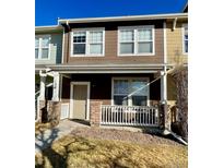 Charming townhome with a cozy front porch, perfect for enjoying the outdoors at 15612 E 96Th Way # 13E, Commerce City, CO 80022