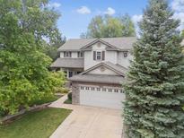 Beautiful two-story home with a well-manicured lawn and a two car garage at 9816 S Holland St, Littleton, CO 80127