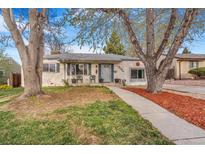 Charming single-story home with a well-maintained front yard, sidewalk and mature trees at 2756 S Linley Ct, Denver, CO 80236