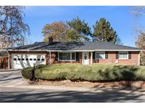 Brick ranch house with attached garage and landscaped front yard at 12019 W Mexico Ave, Lakewood, CO 80228